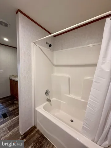 a bathroom with a bathtub and a shower