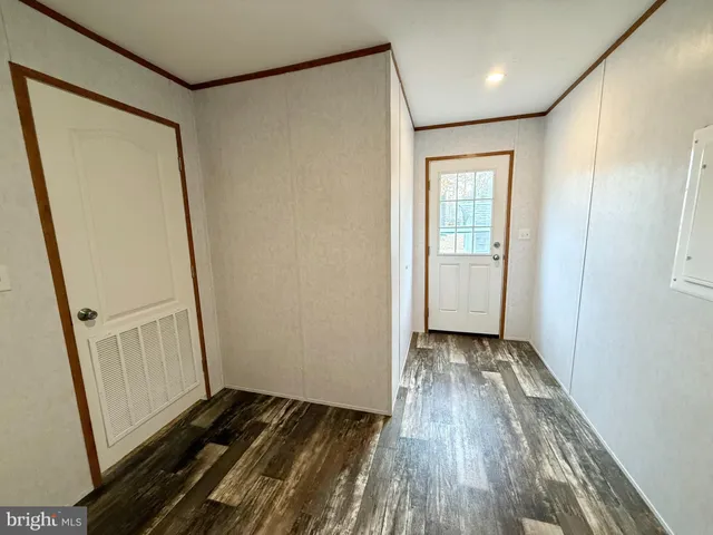 a view of a room with wooden floor and staircase