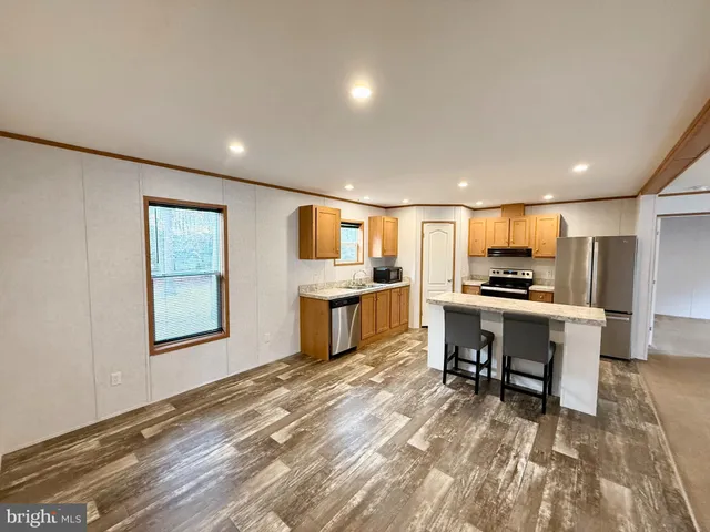a view of kitchen with microwave oven dining table and chairs