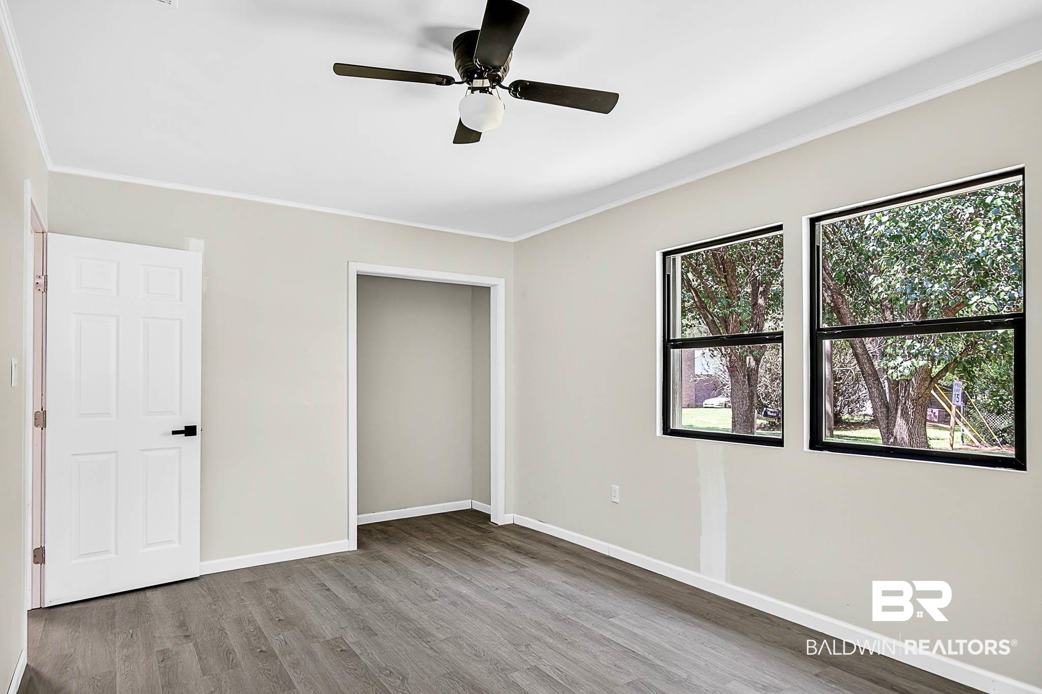 101 Terry Avenue Brewton, AL 36426 - Photo 39 of 48 Unfurnished bedroom featuring crown molding, wood finished floors, a closet, and a ceiling fan
