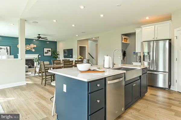 a kitchen with stainless steel appliances granite countertop a sink and a refrigerator
