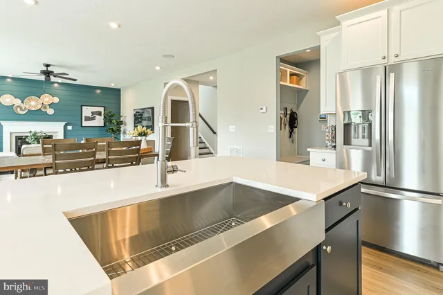 a kitchen with stainless steel appliances kitchen island granite countertop a stove sink and cabinets