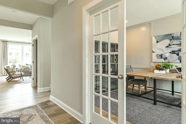 an entryway with wooden floor and windows
