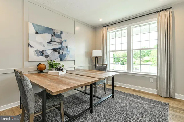 a spacious bedroom with a bed a window and dresser