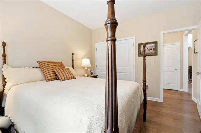 a bedroom with a bed and a mirror