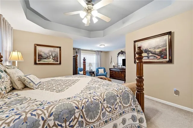 a bedroom with a large bed and a chandelier