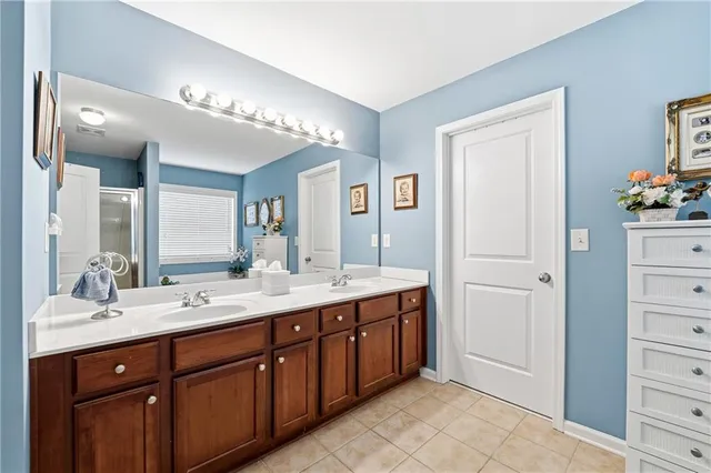 a spacious bathroom with a double vanity sink mirror and
