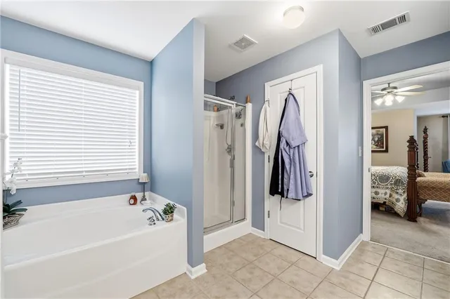 a view of a bathroom with tub and shower