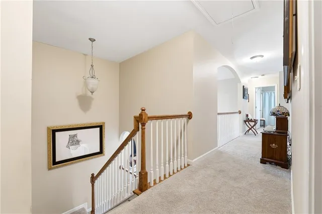 a view of a hallway with paintings on the wall