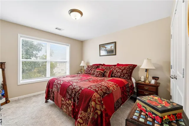 a bedroom with bed and a window