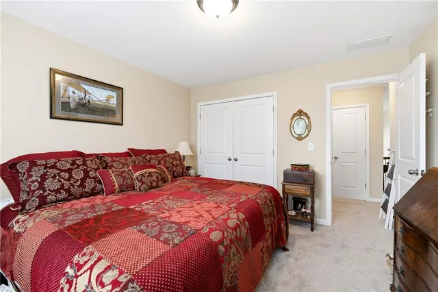 a bed room with a bed mirror and a window