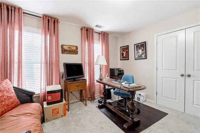 a view of a livingroom with workspace and a window