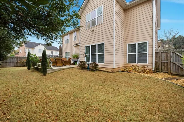 a backyard of a house with barbeque oven and a fountain