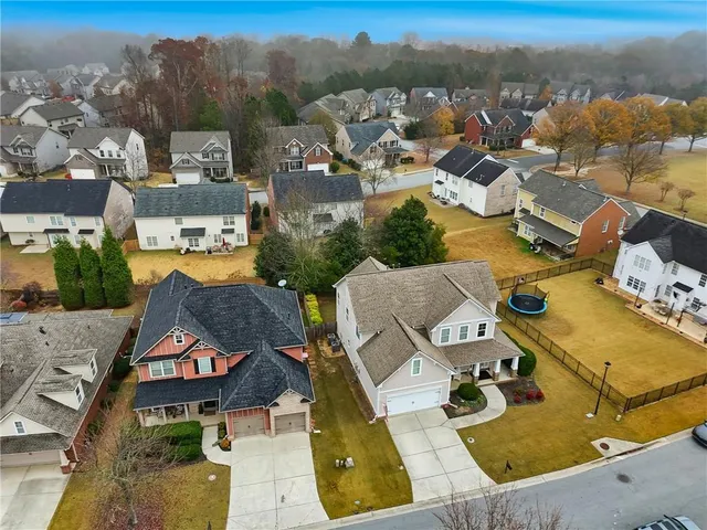 an aerial view of a house with garden space and lake view
