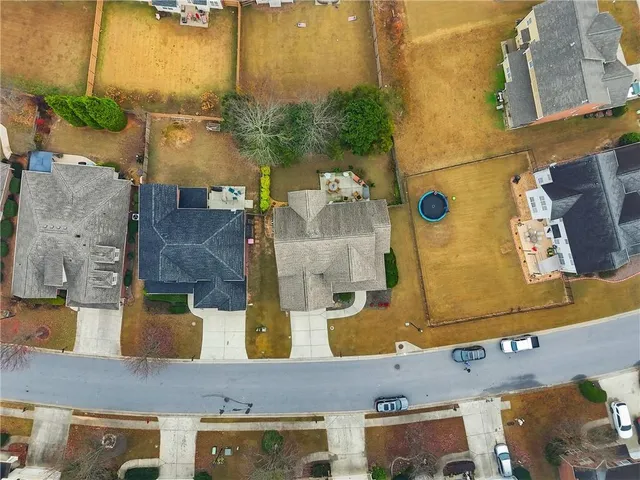 an aerial view of residential houses with outdoor space