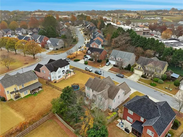 an aerial view of a residential houses with outdoor space