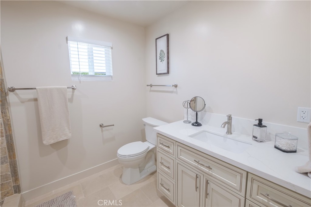 223 South Aprilia Avenue Compton, CA 90220 - Photo 21 of 46 a bathroom with a sink toilet and a window