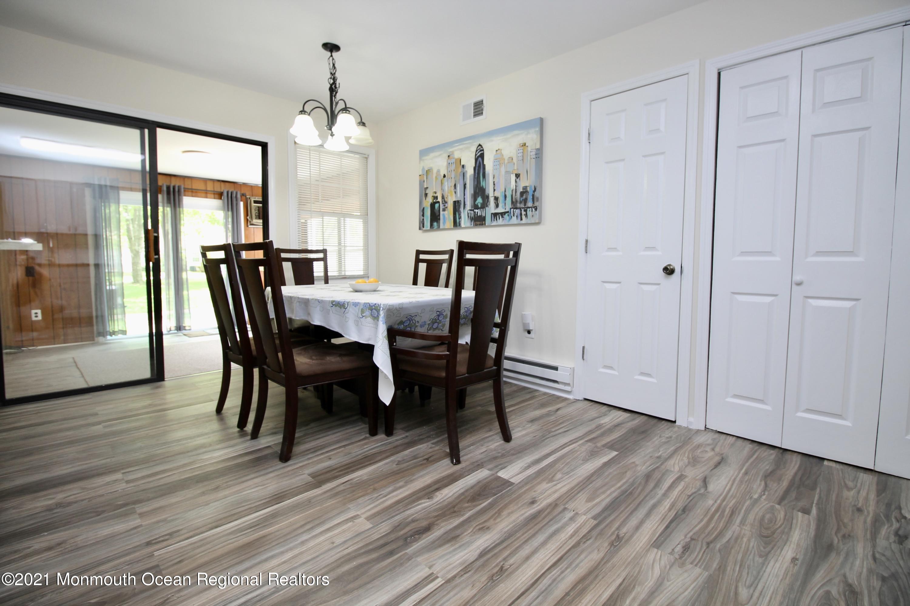 152 Cours De Pasteur, Unit E Freehold, NJ 07728 - Photo 11 of 21 a view of a dining room with furniture window and wooden floor