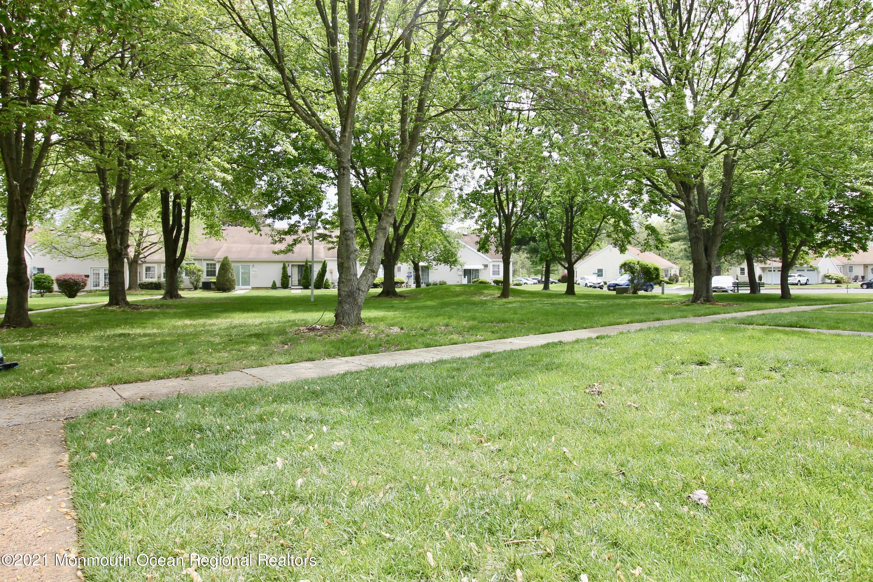 152 Cours De Pasteur, Unit E Freehold, NJ 07728 - Photo 19 of 21 a view of a trees in a park