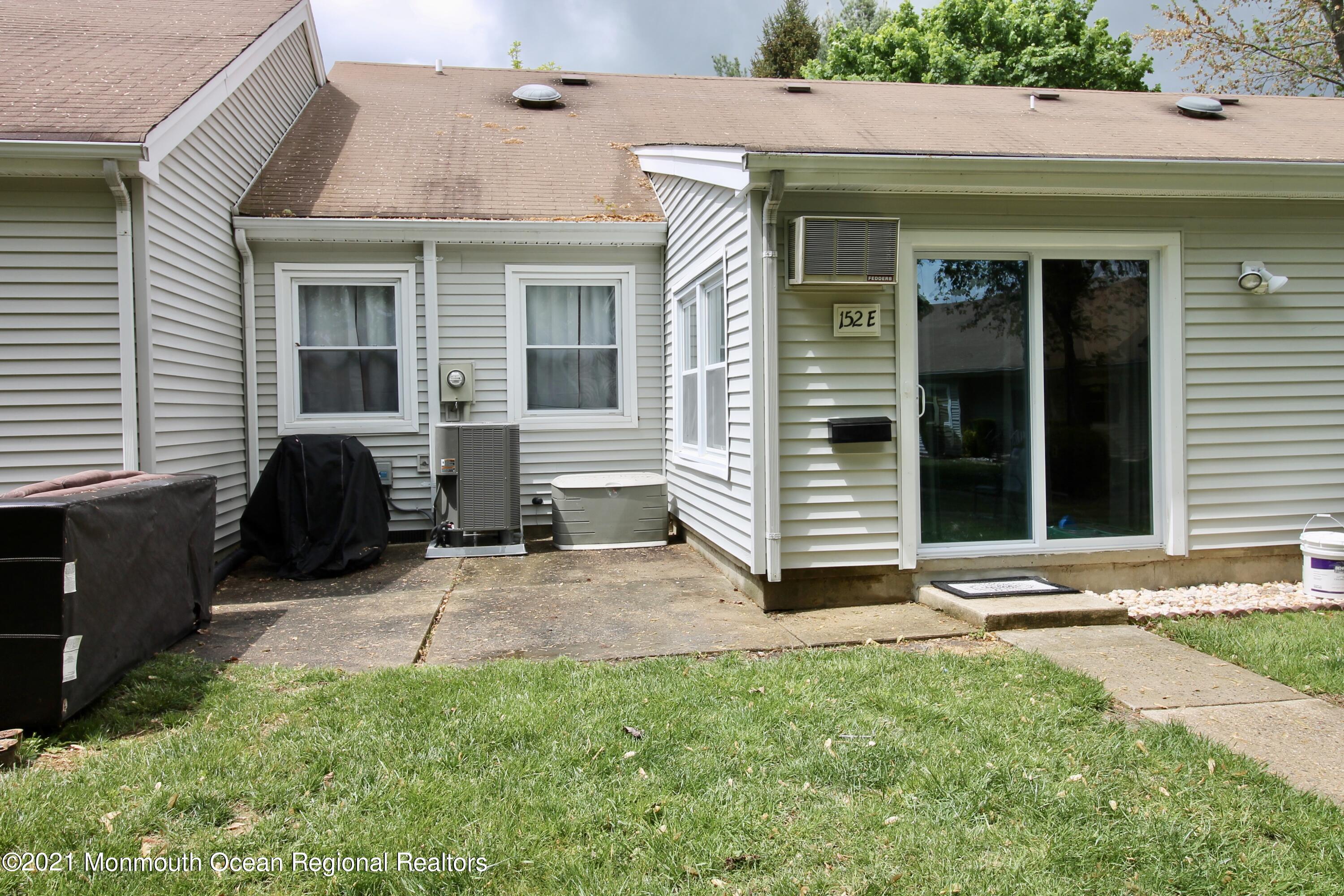 152 Cours De Pasteur, Unit E Freehold, NJ 07728 - Photo 20 of 21 a view of a house with backyard and sitting area