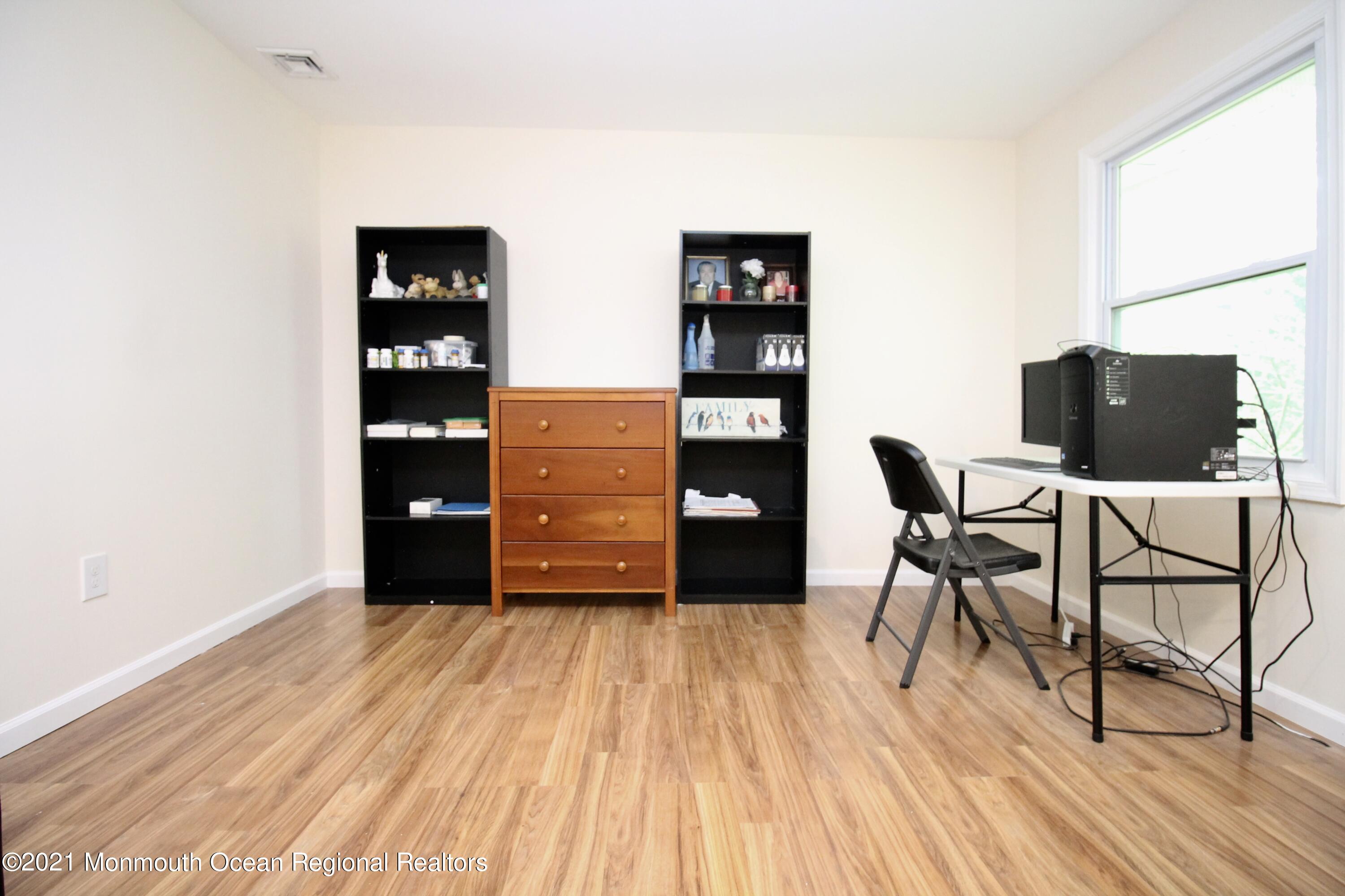 152 Cours De Pasteur, Unit E Freehold, NJ 07728 - Photo 5 of 21 a room with furniture and wooden floor