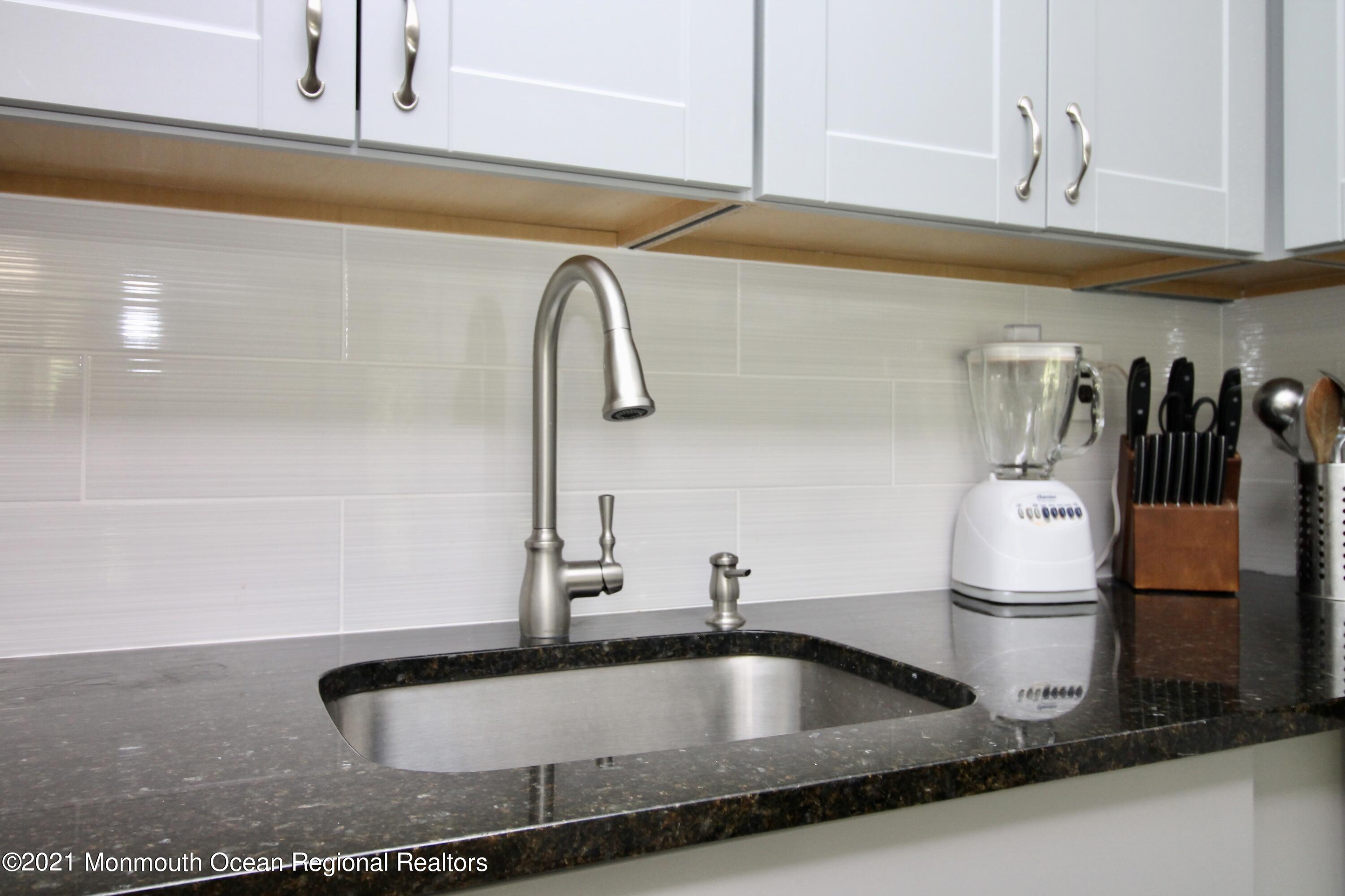 152 Cours De Pasteur, Unit E Freehold, NJ 07728 - Photo 10 of 21 a kitchen with a sink and tub