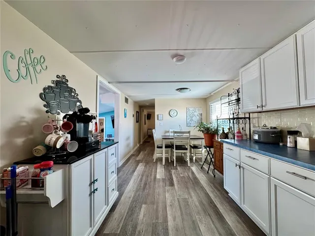 a kitchen filled with a white stove top oven and cabinets