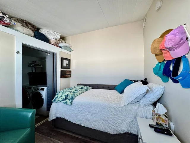 a bedroom with a bed and ceiling fan