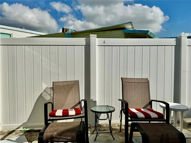 a patio with table and chairs