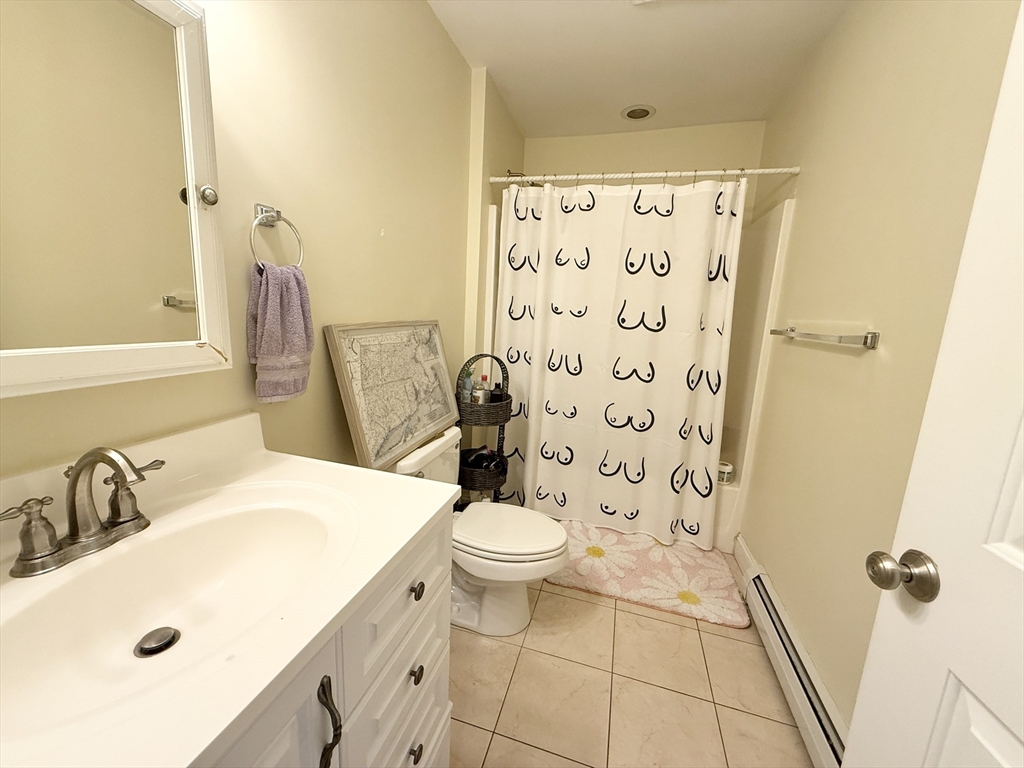 36 Hawthorne Street, Unit 1 Boston, MA 02119 - Photo 11 of 12 a bathroom with a sink toilet and shower
