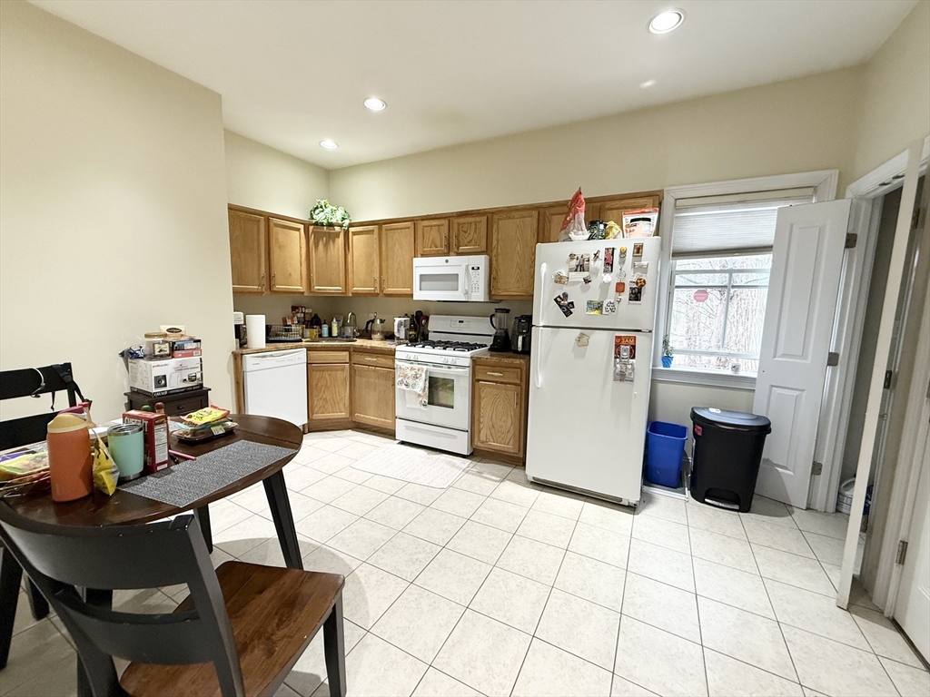 36 Hawthorne Street, Unit 1 Boston, MA 02119 - Photo 12 of 12 a kitchen with a refrigerator and a stove top oven
