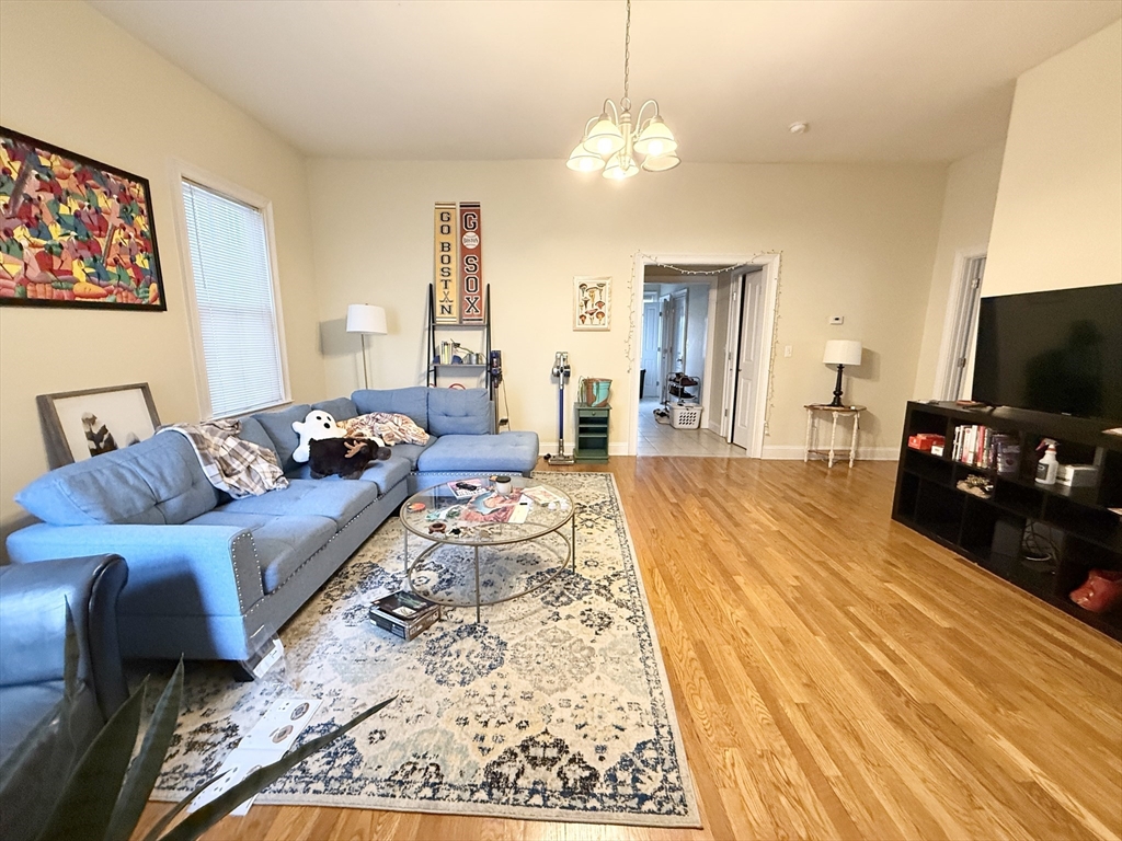 36 Hawthorne Street, Unit 1 Boston, MA 02119 - Photo 2 of 12 a spacious bedroom with a bed and a flat screen tv