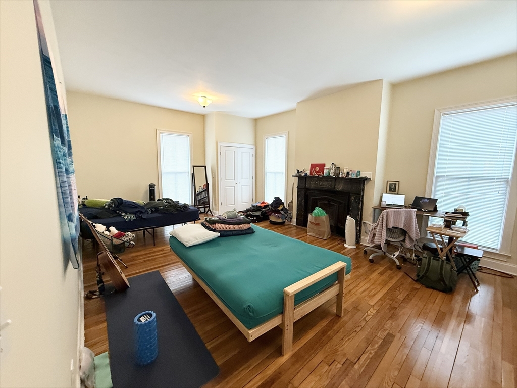 36 Hawthorne Street, Unit 1 Boston, MA 02119 - Photo 6 of 12 a living room with furniture and a fireplace
