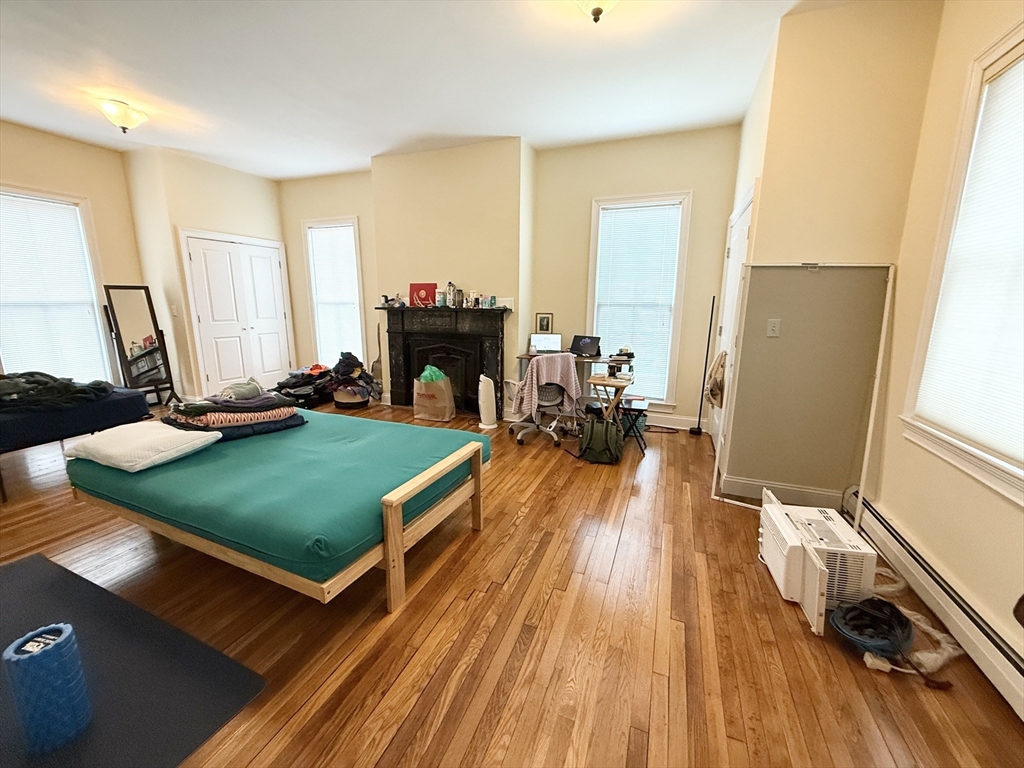 36 Hawthorne Street, Unit 1 Boston, MA 02119 - Photo 7 of 12 a living room with furniture flat screen tv and a wooden floor