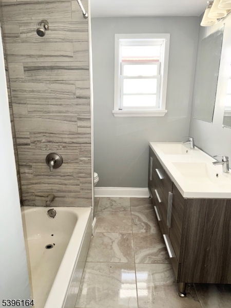 42 Clinton Place, Unit 2 Newark, NJ 07108 - Photo 14 of 20 a bathroom with a tub a sink a mirror and a shower