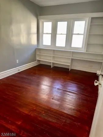 a view of room with window and hardwood floor