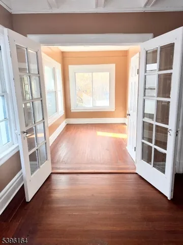 a view of a room with wooden floor and window