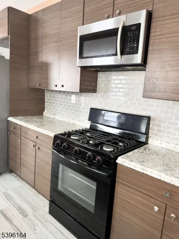 a kitchen with a stove and a microwave
