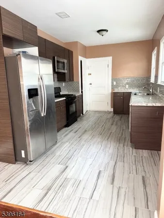 a kitchen with stainless steel appliances a refrigerator and a sink
