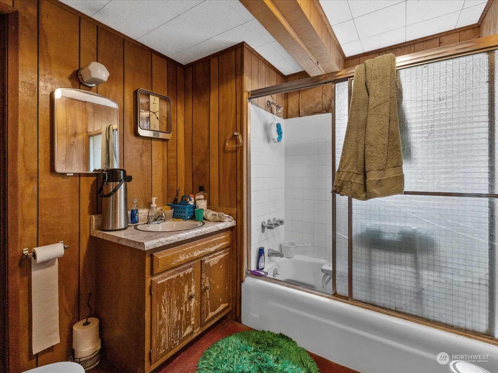 8832 Interlake Avenue North Seattle, WA 98103 - Photo 18 of 29 a bathroom with a sink a mirror and a bathtub