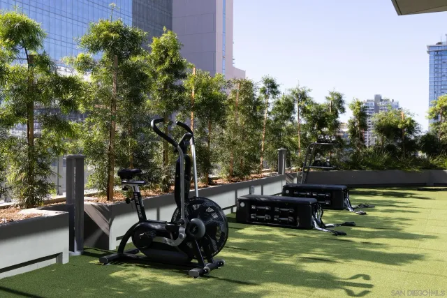 a view of a patio with plants and chairs