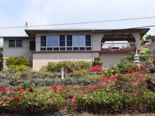 81-1018 Captain Cook Road Captain Cook, HI 96704 - Photo 1 of 24 a front view of a house with a yard and fountain