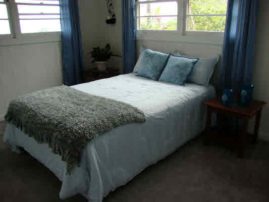81-1018 Captain Cook Road Captain Cook, HI 96704 - Photo 5 of 24 a bed sitting in a bedroom next to a window