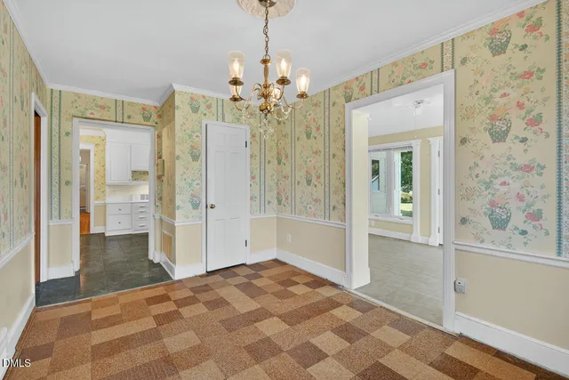a view of a big room with windows and chandelier