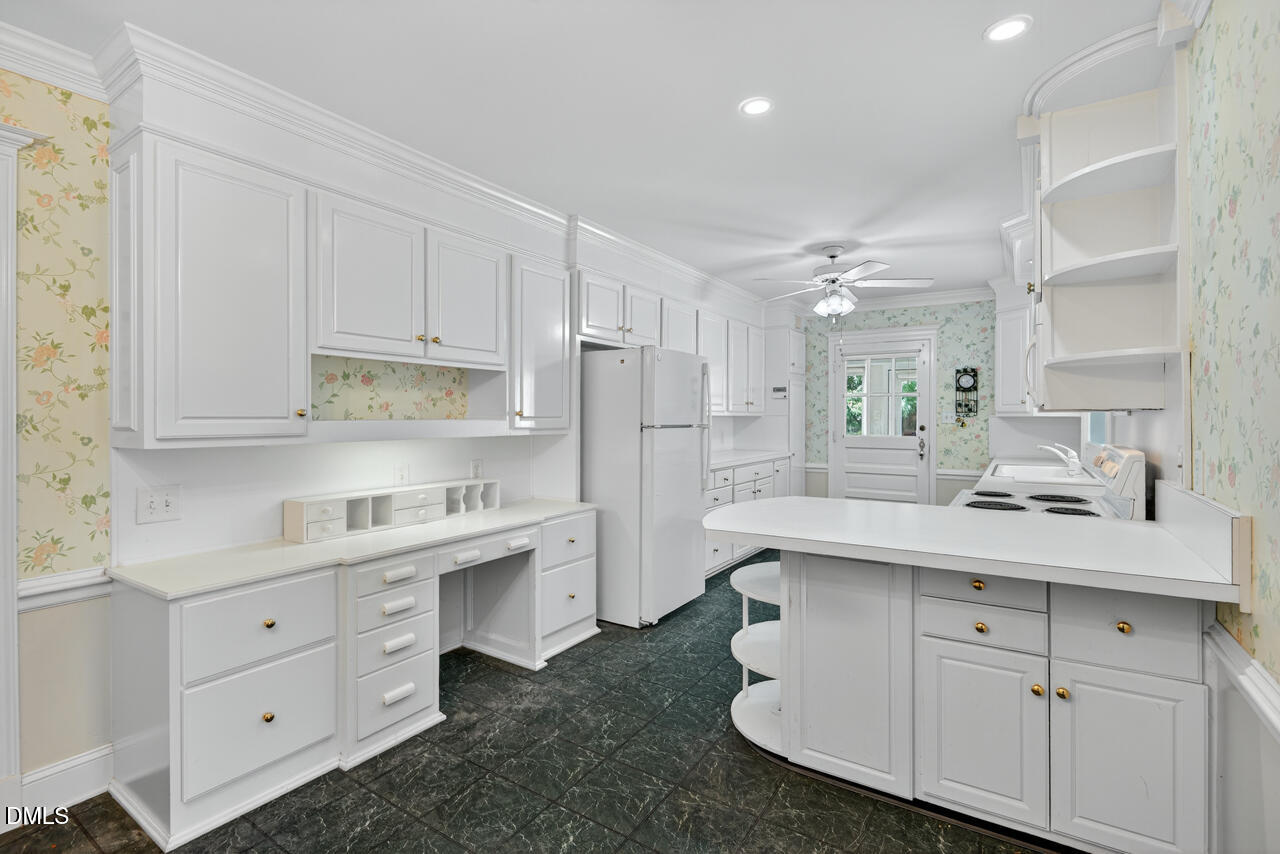 720 Roxboro Road Haw River, NC 27258 - Photo 12 of 55 a kitchen with white cabinets appliances and sink