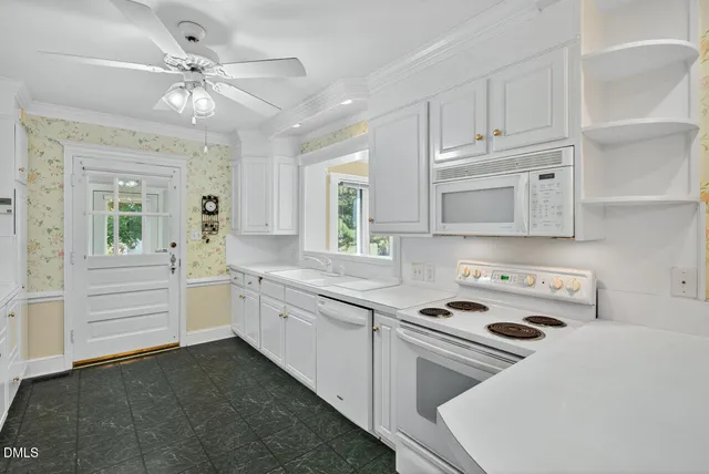 a kitchen with kitchen island white cabinets and white appliances