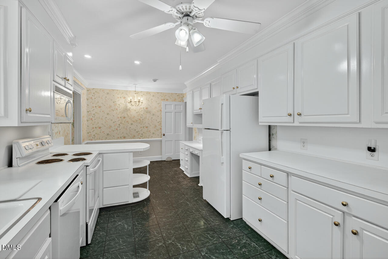 720 Roxboro Road Haw River, NC 27258 - Photo 17 of 55 a kitchen with sink cabinets and refrigerator