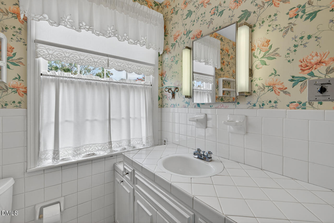 720 Roxboro Road Haw River, NC 27258 - Photo 24 of 55 a bathroom with a sink and a mirror