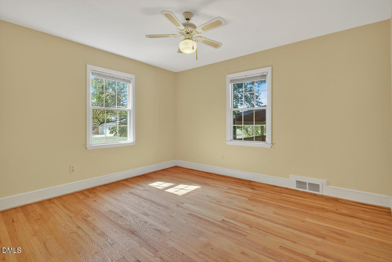 720 Roxboro Road Haw River, NC 27258 - Photo 26 of 55 a view of an empty room with wooden floor and a window