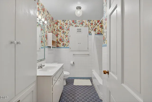 a en suite bathroom with a sink double vanity and mirror